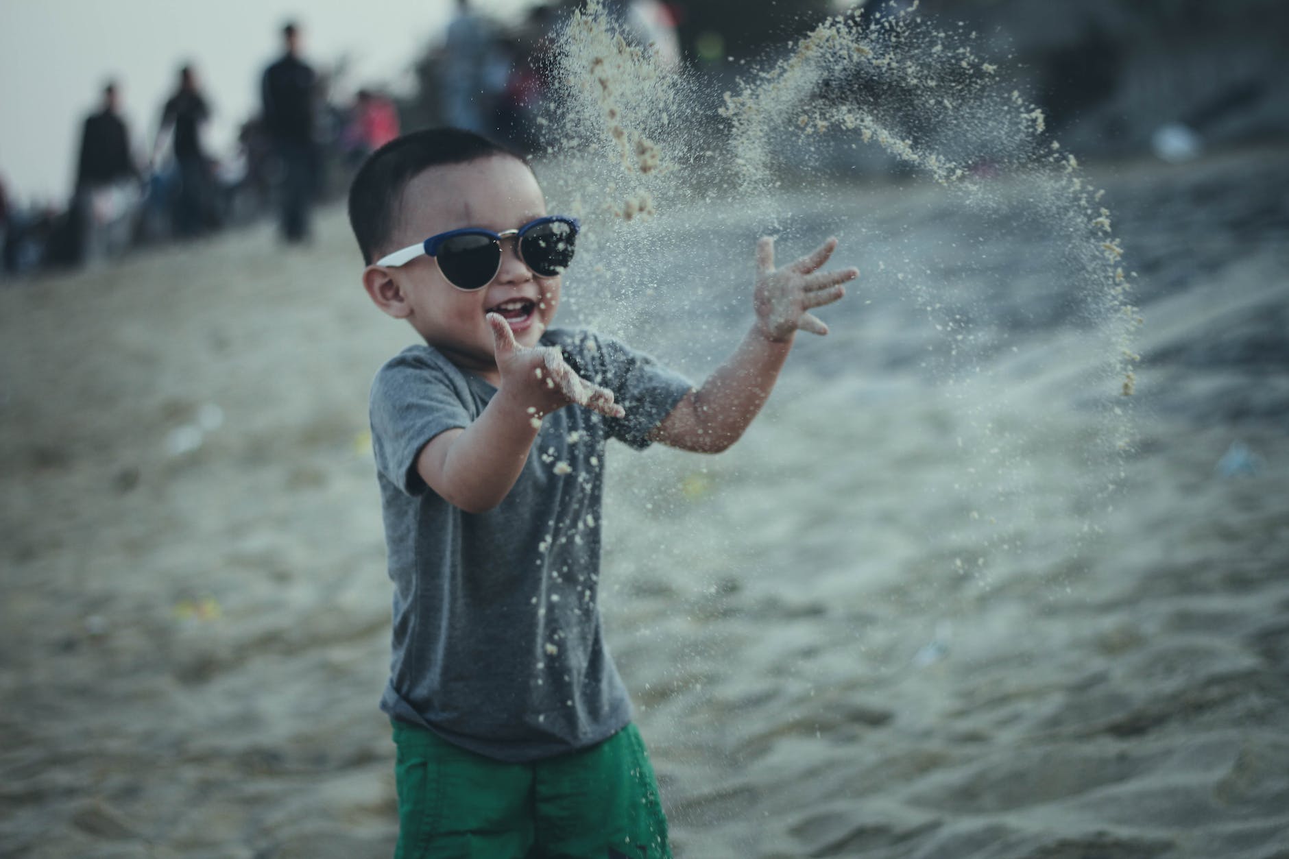 boy throwing sands